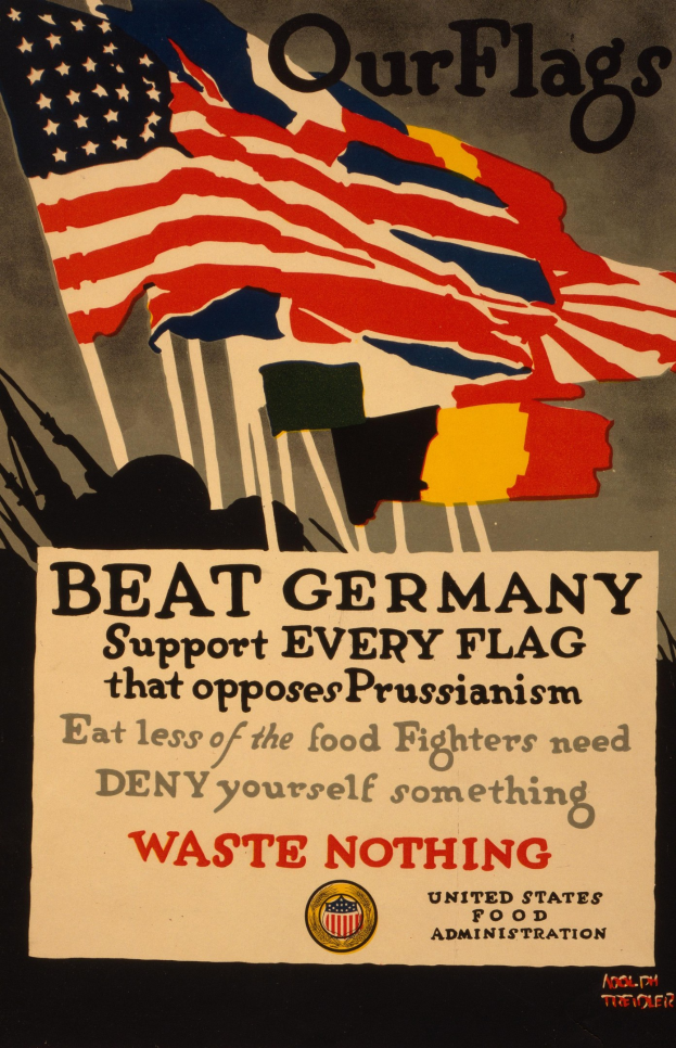Plakat mit einer roten, weißen und blauen Flagge mit einem weißen Stern, schwarzem, fetten Text "Unsere Flaggen schlagen Deutschland - Unterstützt jede Flagge, die gegen Preußentum kämpft" und einem weißen Rand, das die Opposition gegen das Preußentum fordert.