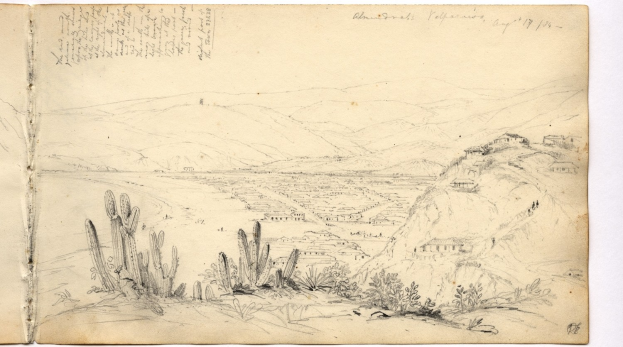 Ein aufgeschlagenes Buch mit einer Illustration einer Wüstenlandschaft mit Hügeln, Pflanzen und Text.