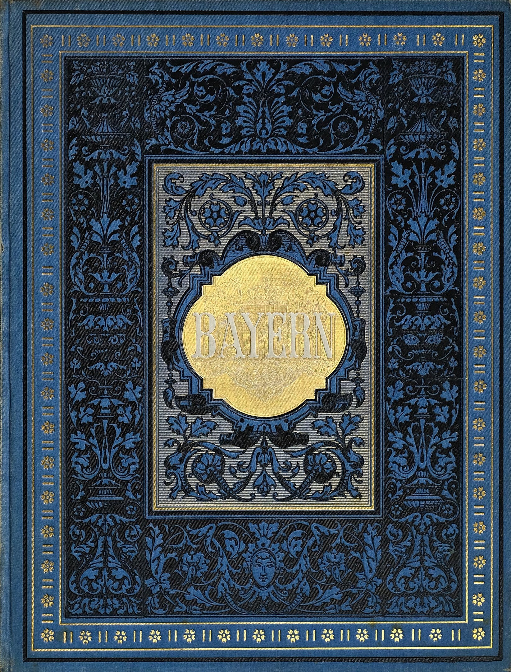 Ein blau-goldenes Buch mit dem Wort "Bayern" auf einem kunstvoll gestalteten Einband.